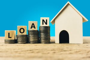 quickloansutah home loan concept with coins and wooden house
